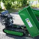 Mini dumper à chenilles vert stationné avec benne hydraulique en position de déversement, logo ChargeurPlus.