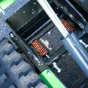 Système de suspension avec ressorts amortisseurs et vérin de levage d’un dumper Chargeur Plus à chenilles, vue rapprochée du châssis