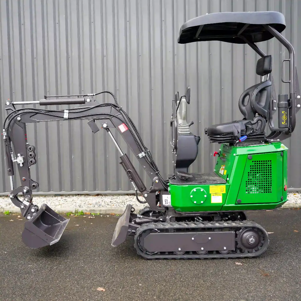 Chargeurplus: Vue latérale complète de la mini-pelle sur chenilles, équipée d’un bras hydraulique articulé, d’un godet de terrassement, d’une lame de nivellement et d’un poste de conduite avec toit de protection.