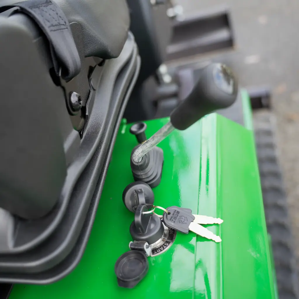 Chargeurplus vous présente un gros plan sur le contacteur de démarrage à clé de la CP09, avec ses deux clés sur le trousseau, entouré de commutateurs et prises étanches sur la carrosserie verte.